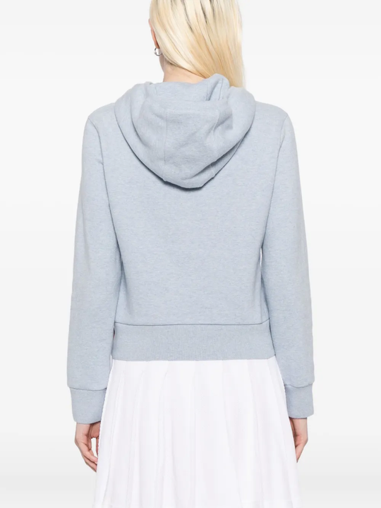 blue hoodie worn by a person, showing the hoodie fit