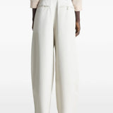 White pants worn by a person, showing the pants fit