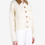 Tan knitwear worn by a person, showing the knitwear fit