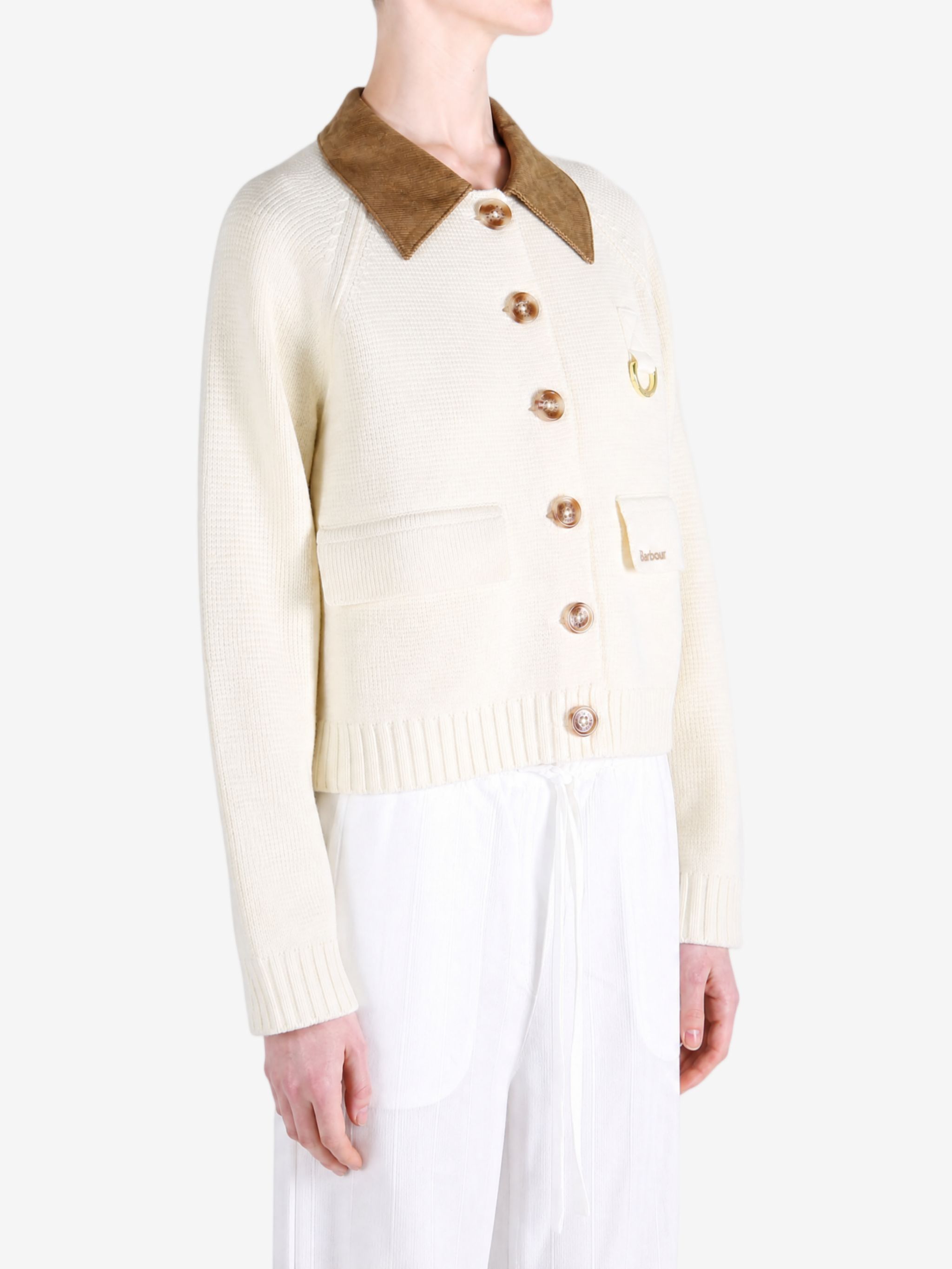 Tan knitwear worn by a person, showing the knitwear fit