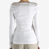 White tops worn by a person, showing the tops fit