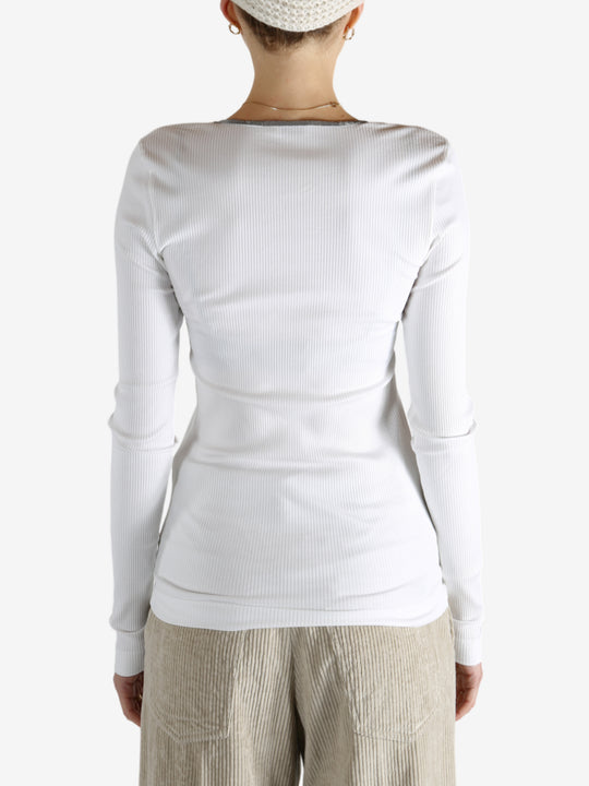 White tops worn by a person, showing the tops fit