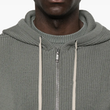 Grey hoodie worn by a person, showing the hoodie fit