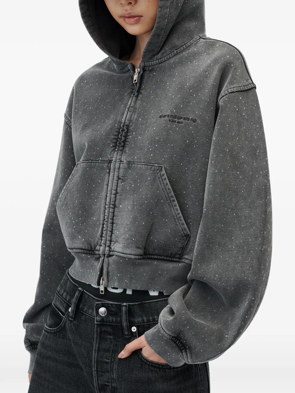 Grey hoodie worn by a person, showing the hoodie fit