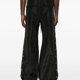 Black pants worn by a person, showing the pants' fit