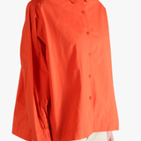Red shirt worn by a person, showing the shirt's fit