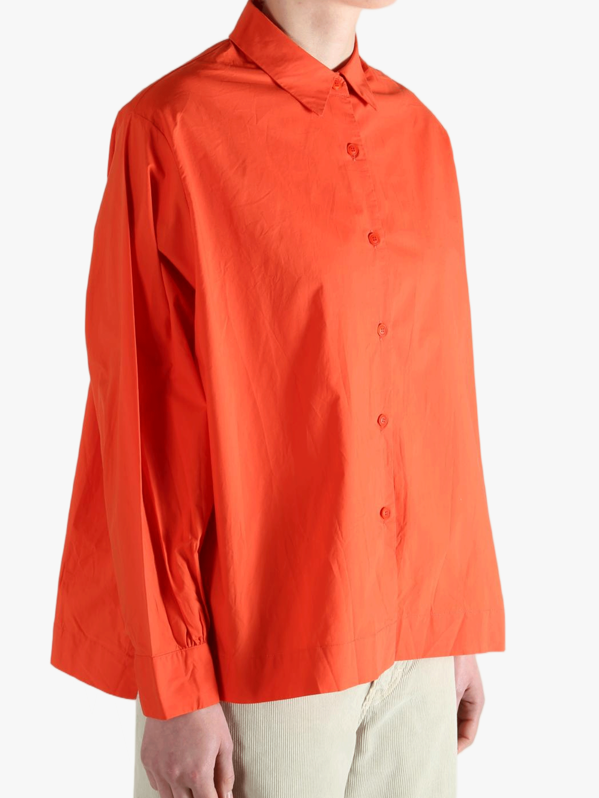 Red shirt worn by a person, showing the shirt's fit