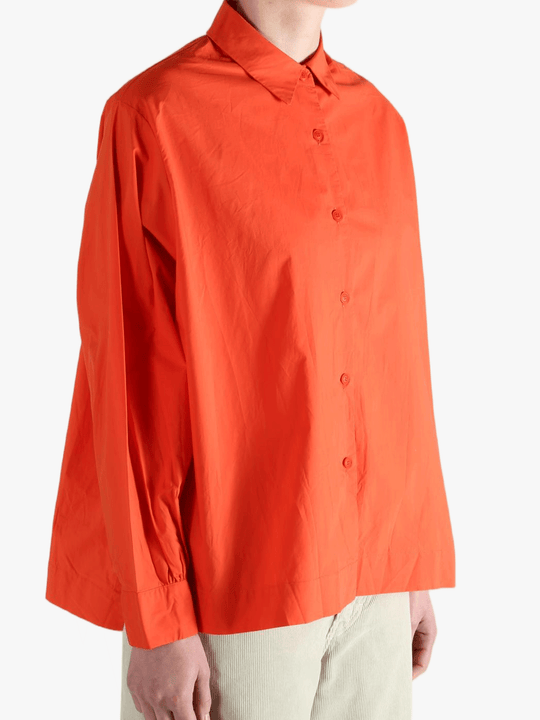 Red shirt worn by a person, showing the shirt's fit