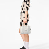 White bag worn by a person, showing the bag's fit