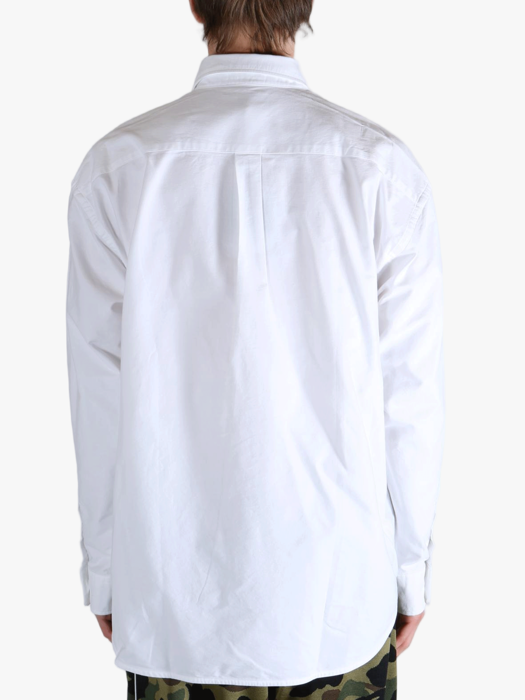 White shirt worn by a person, showing the shirt's fit
