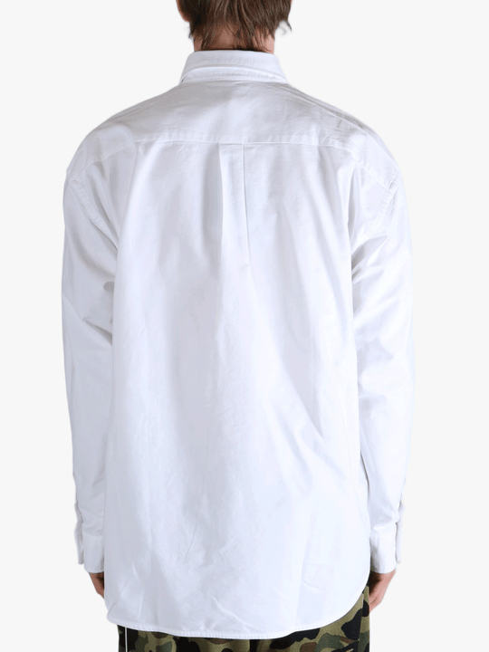 White shirt worn by a person, showing the shirt's fit