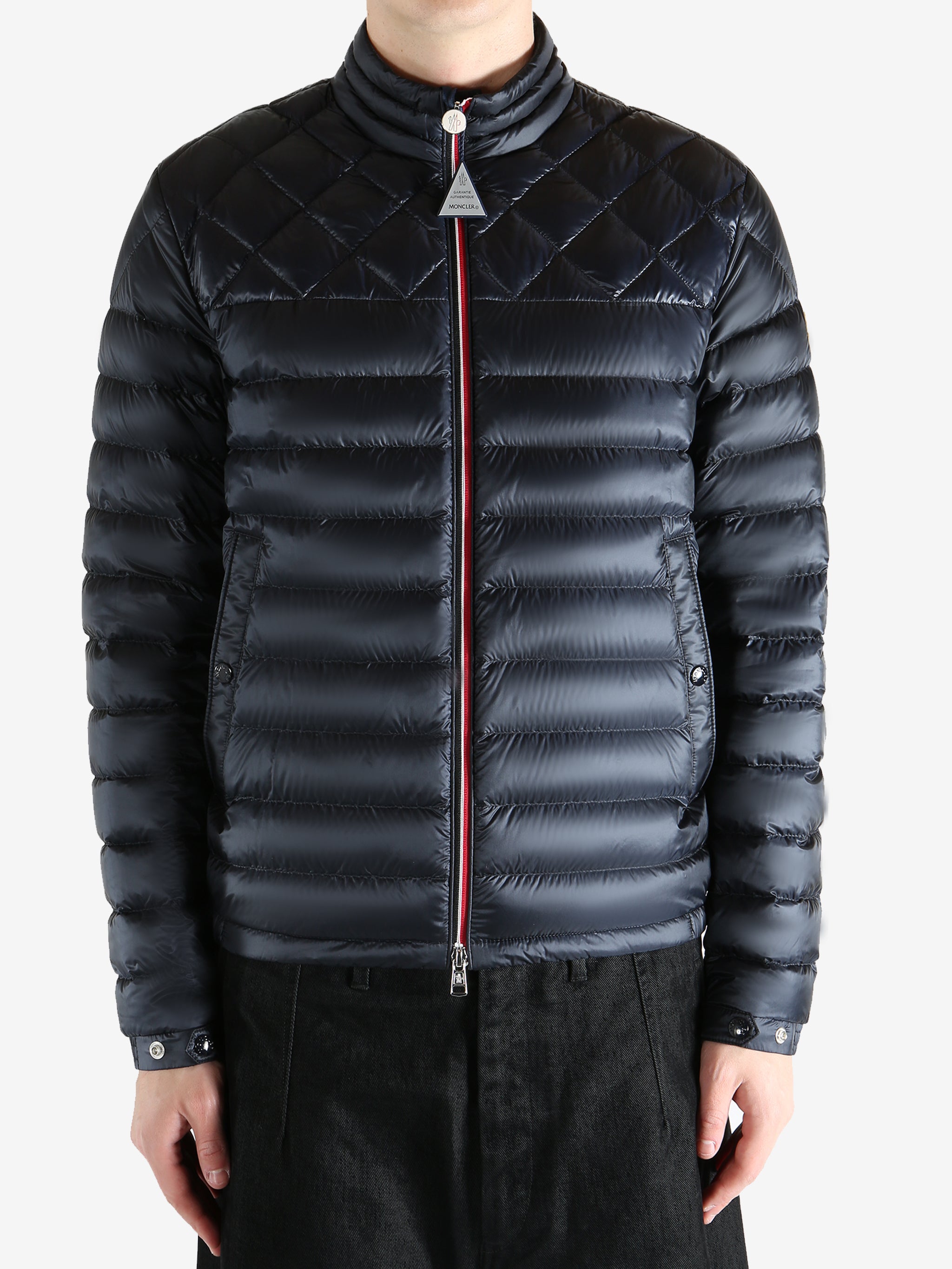 Black jacket worn by a person, showing the jacket fit