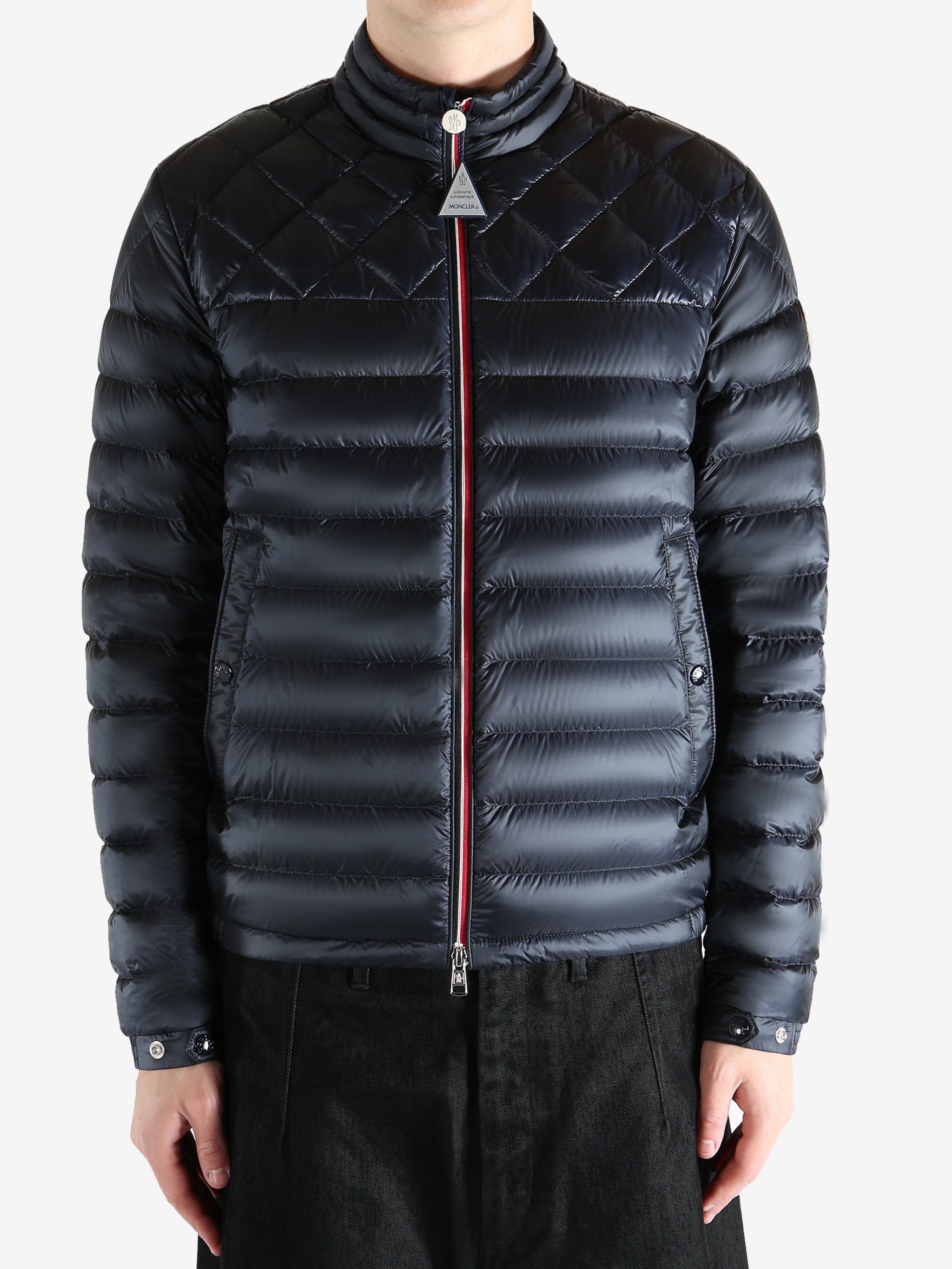 Black jacket worn by a person, showing the jacket fit