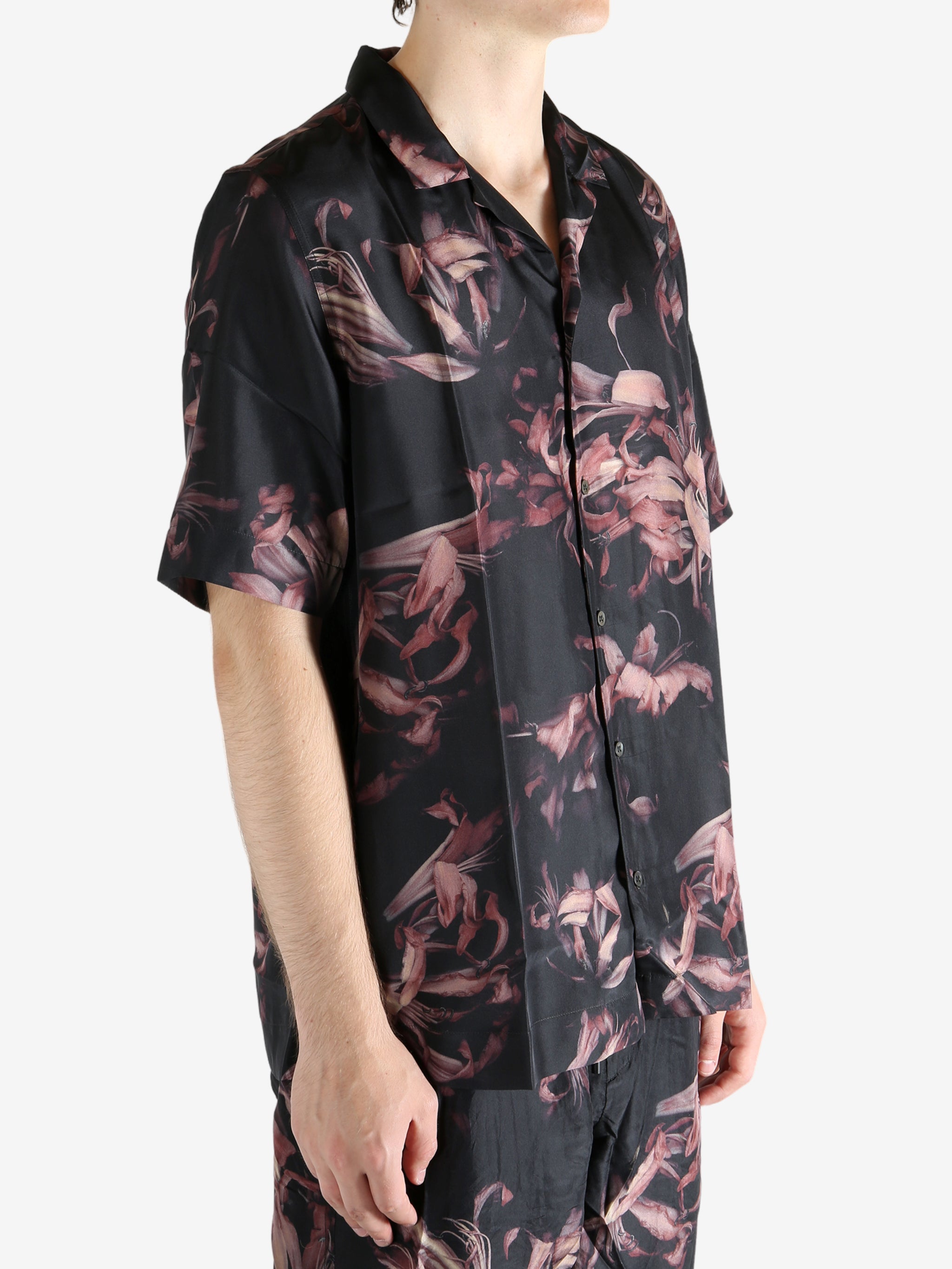 Black shirt worn by a person, showing the shirt's fit