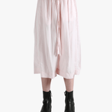 Pink pants worn by a person, showing the pants fit