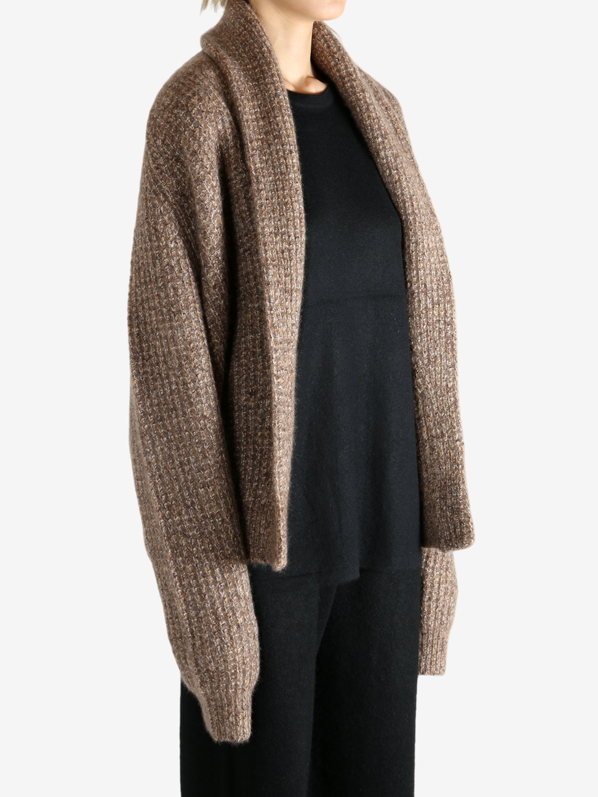 Brown knitwear worn by a person, showing the knitwear's fit