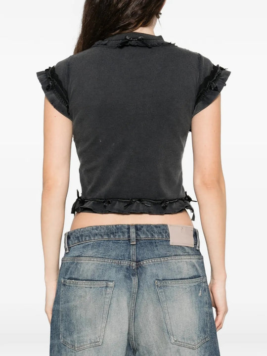 Black t-shirts worn by a person, showing the t-shirts fit