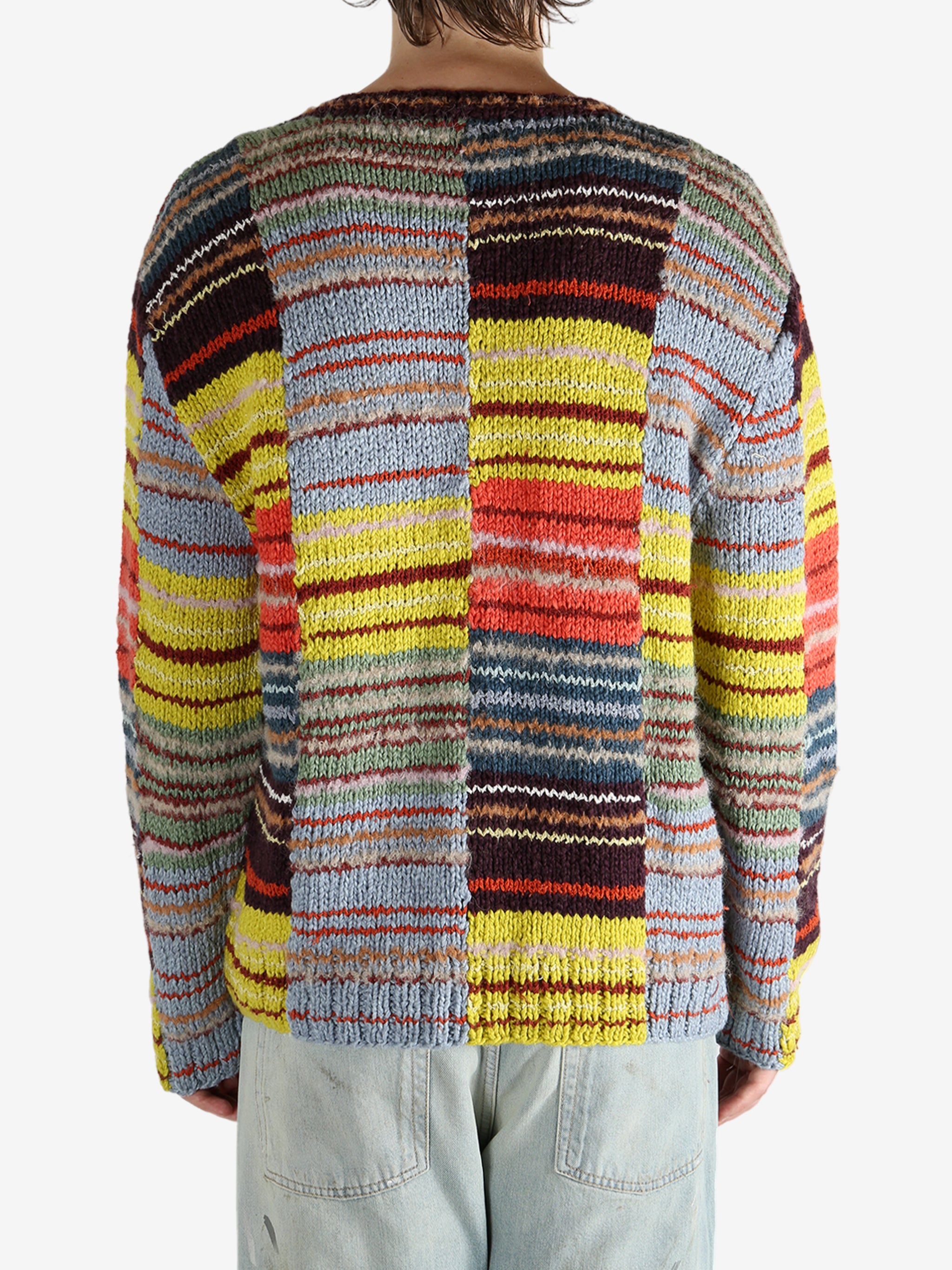 Yellow sweater worn by a person, showing the sweater’s fit