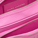 Close up of pink bag, showing texture of the leather fabric