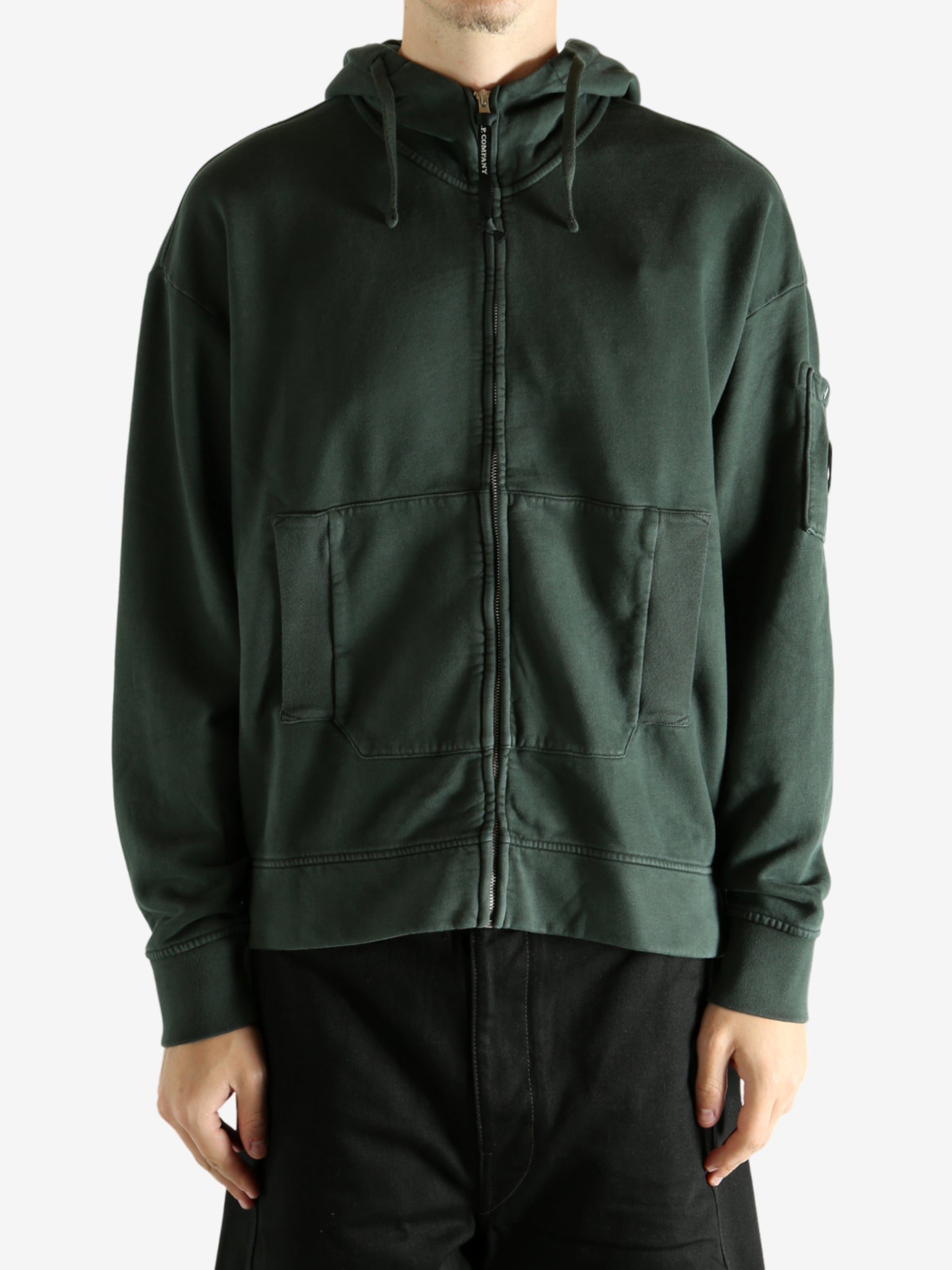 Green hoodie worn by a person, showing the hoodie's fit