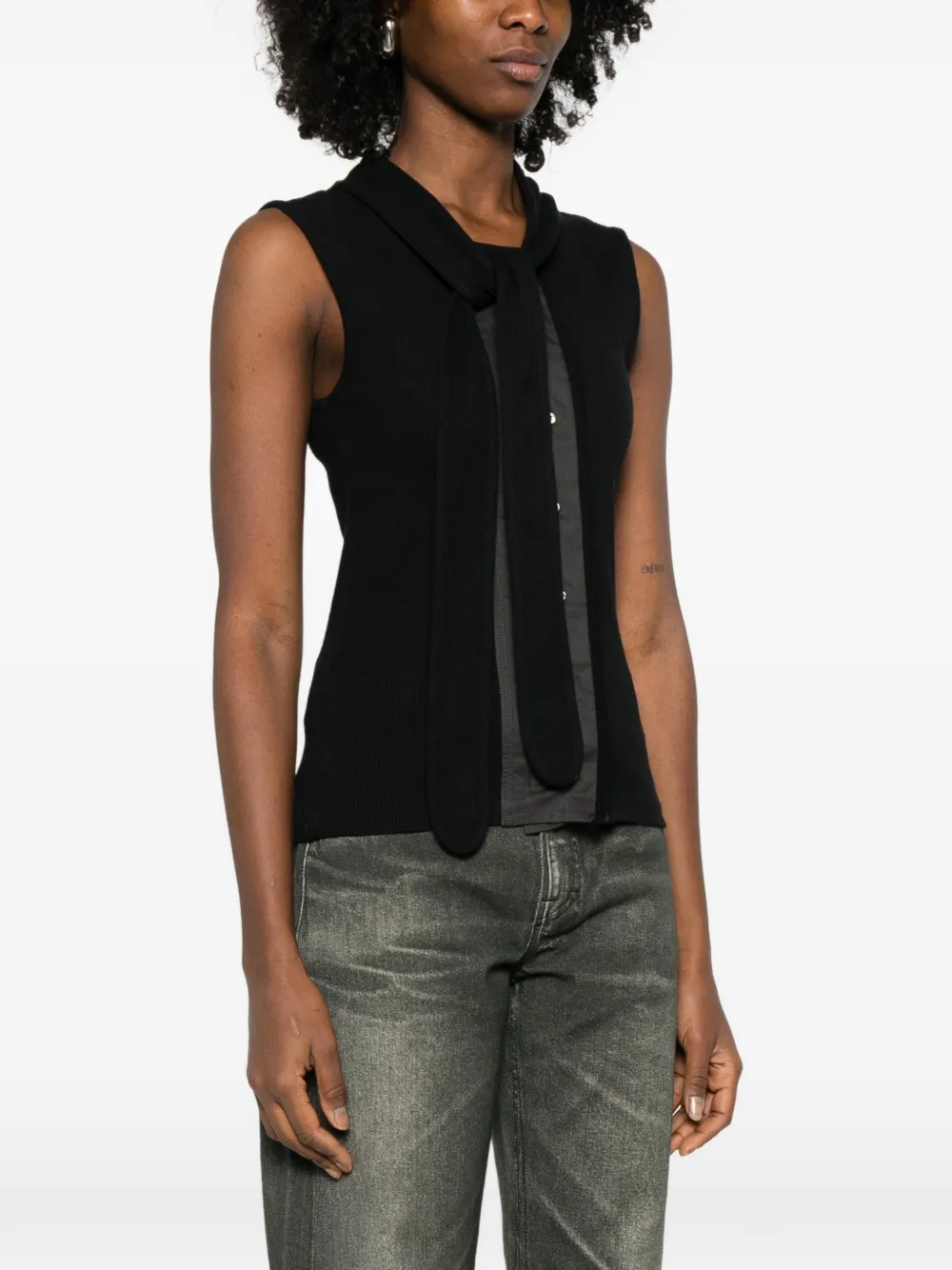 Black top worn by a person, showing the top fit