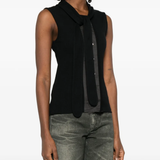 Black top worn by a person, showing the top fit