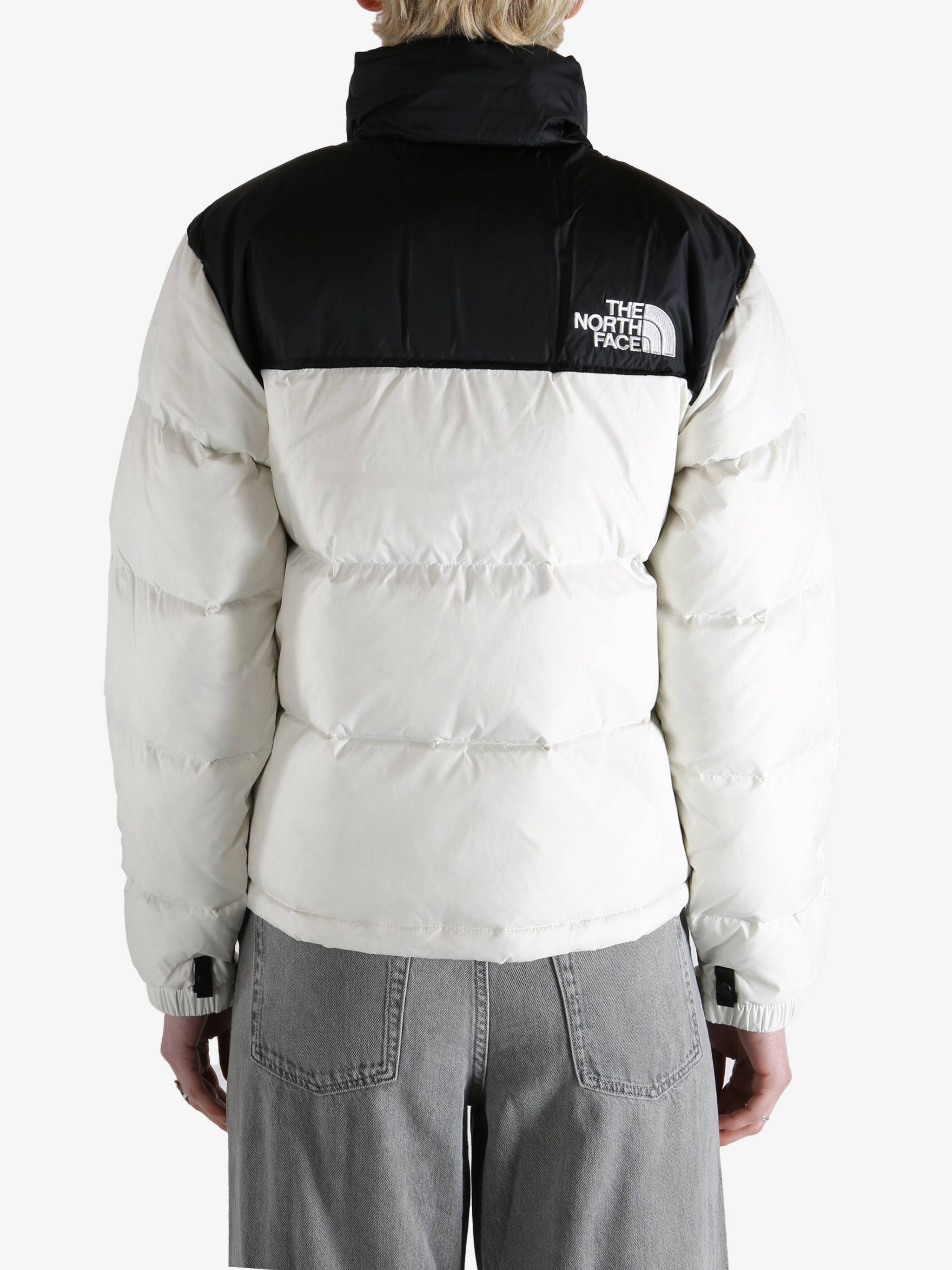  white jacket worn by a person, showing the jacket  fit