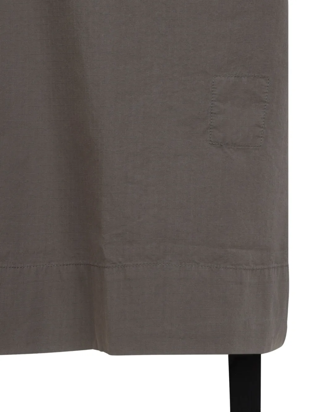 Close up of grey shirt, showing texture of the cotton fabric