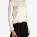 White knitwear worn by a person, showing the knitwear's fit