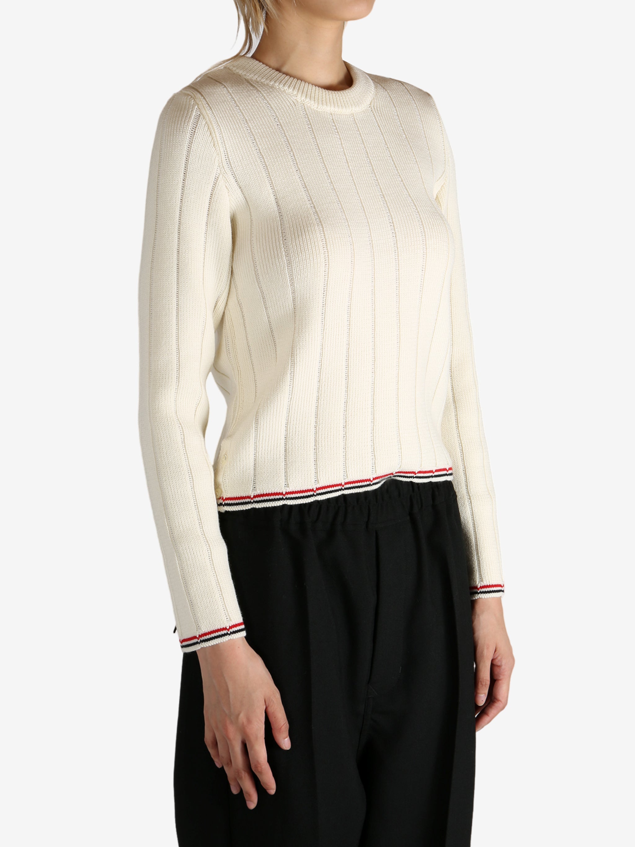 White knitwear worn by a person, showing the knitwear's fit