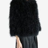 Black coat worn by a person, showing the coat's fit