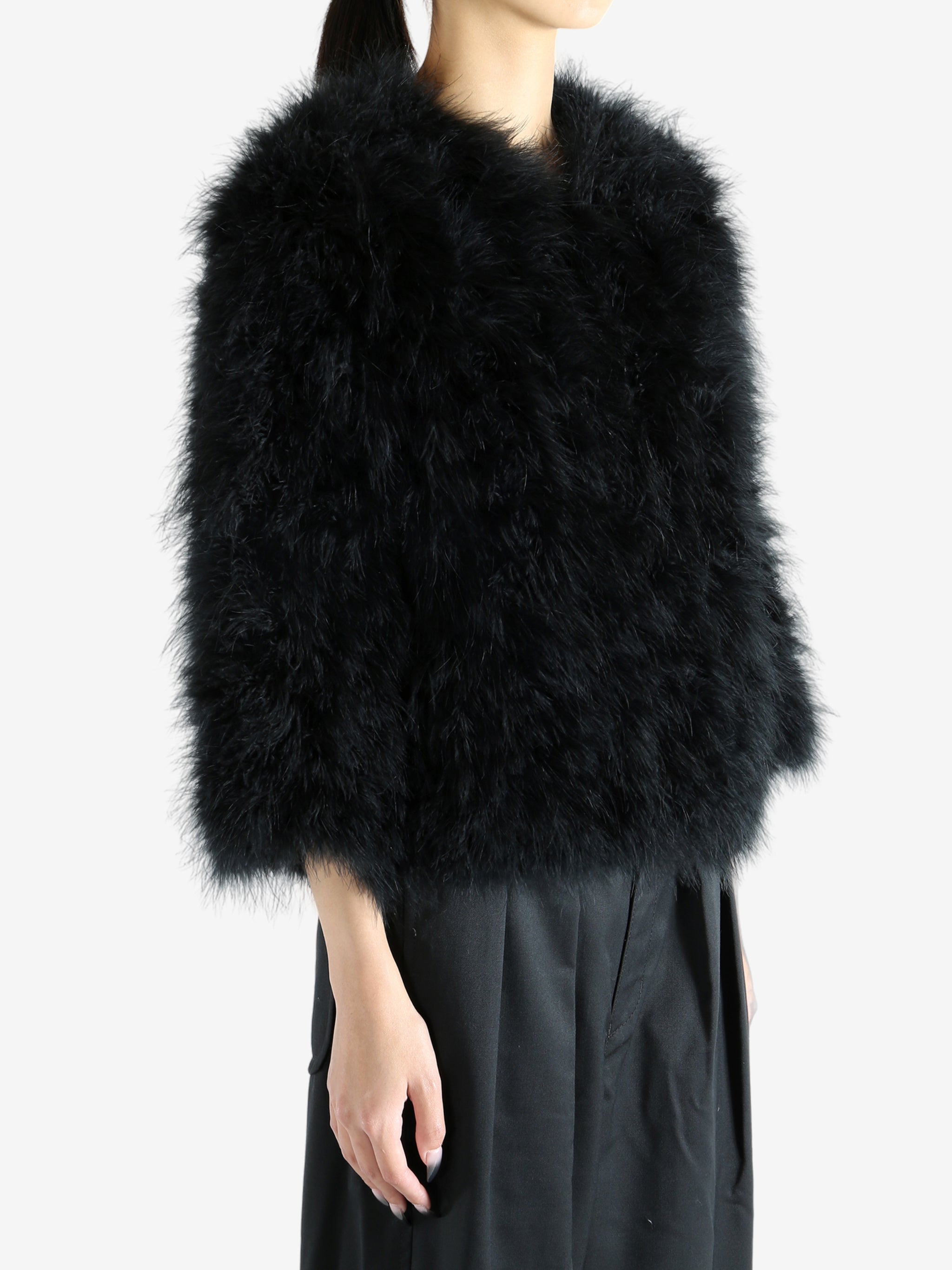 Black coat worn by a person, showing the coat's fit