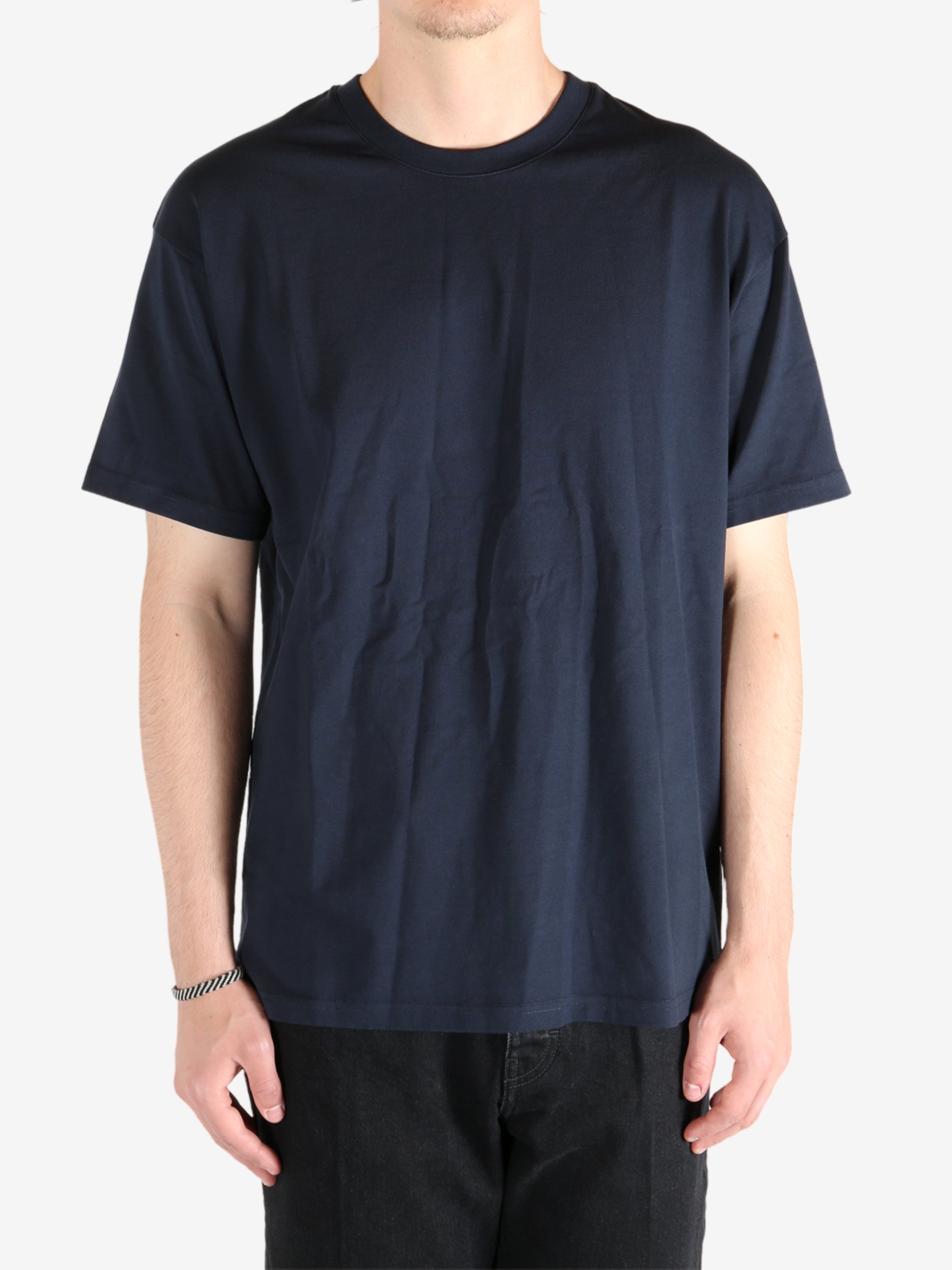 Navy t-shirt worn by a person, showing the t-shirt's fit