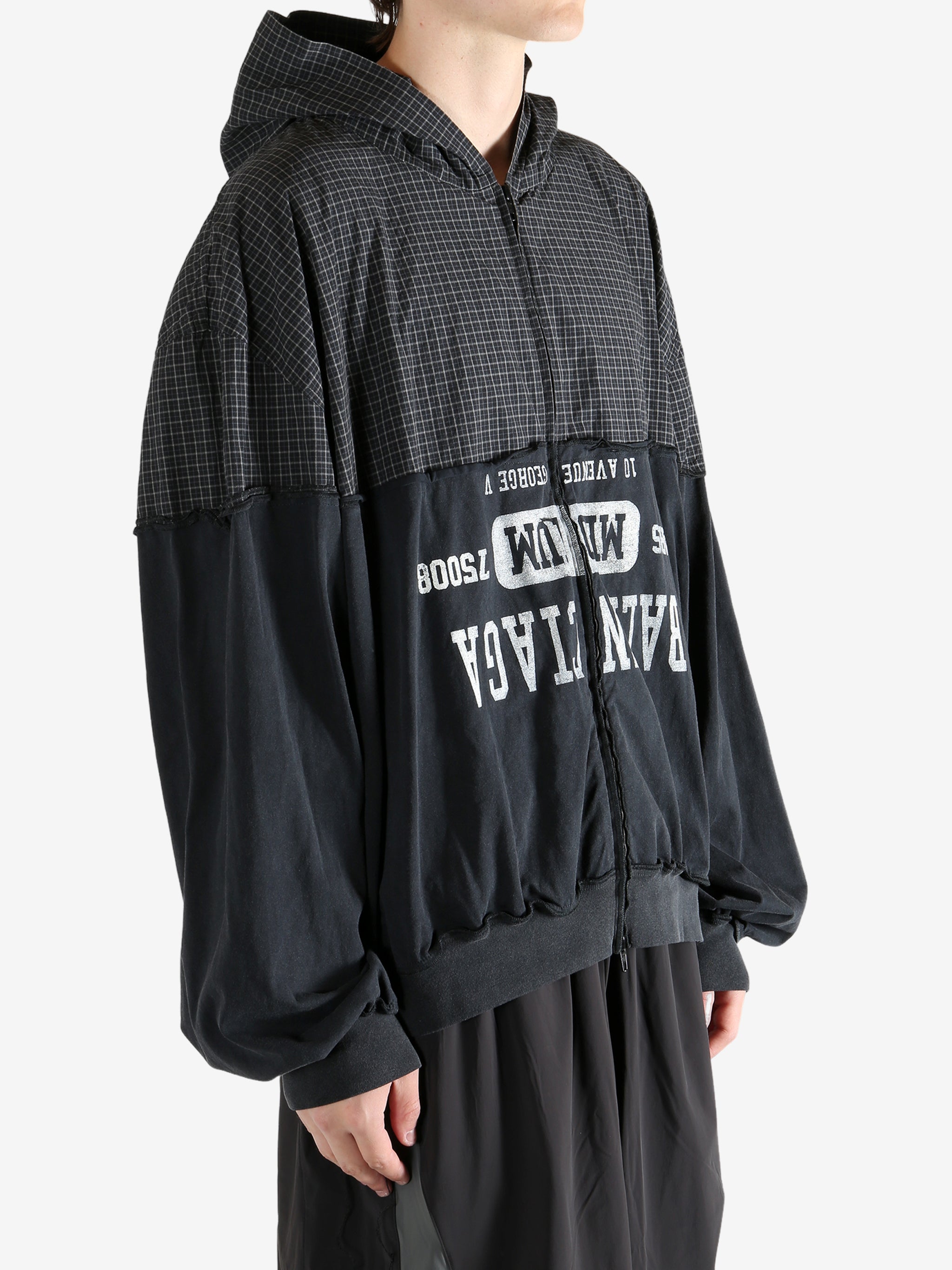 Black sweater worn by a person, showing the sweater's fit