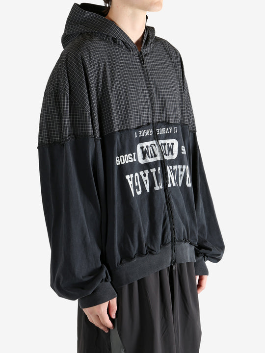 Black sweater worn by a person, showing the sweater's fit