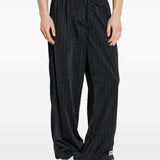 Black pants worn by a person, showing the pants fit