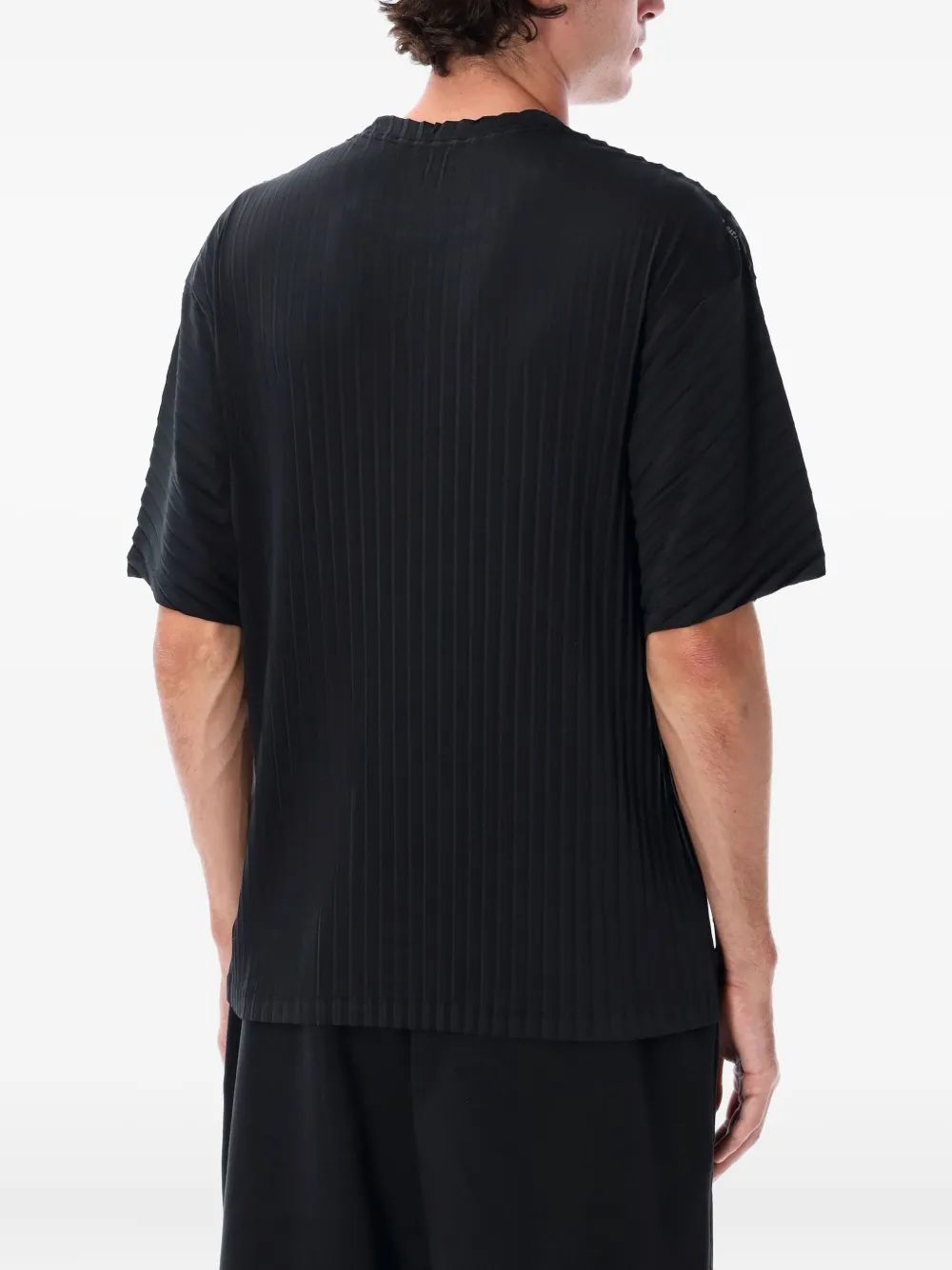 Black t-shirt worn by a person, showing the shirt's fit
