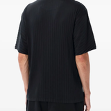 Black t-shirt worn by a person, showing the shirt's fit