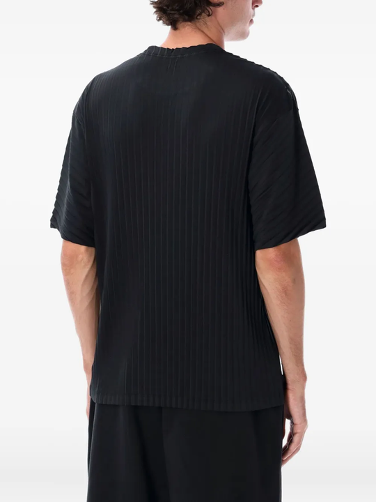Black t-shirt worn by a person, showing the shirt's fit
