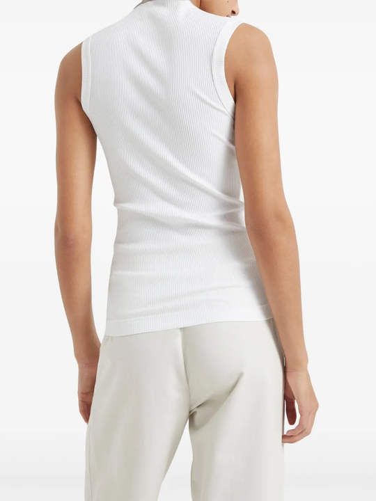 White tops worn by a person, showing the tops fit