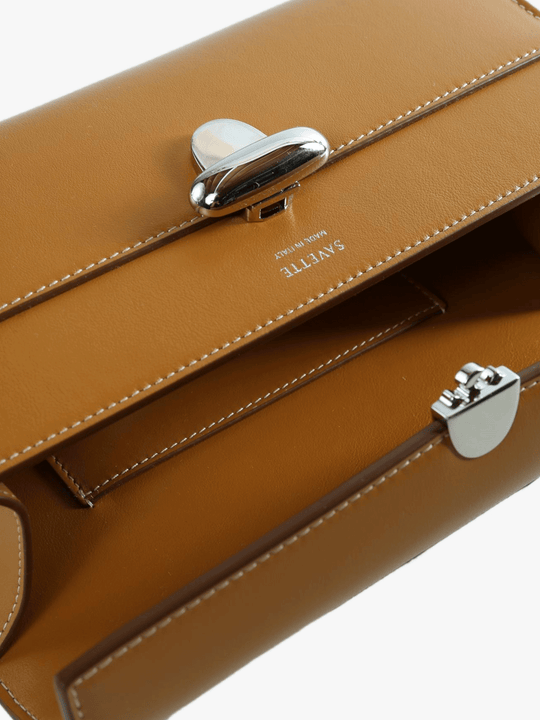 Close up of brown bag, showing texture of the leather fabric