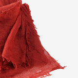 Close up of red scarf, showing texture of the cashmere fabric