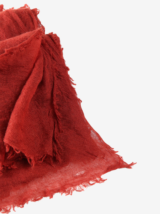 Close up of red scarf, showing texture of the cashmere fabric
