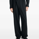 black pants worn by a person, showing the pants fit