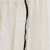 Close up of white skirt, showing texture of the viscose fabric
