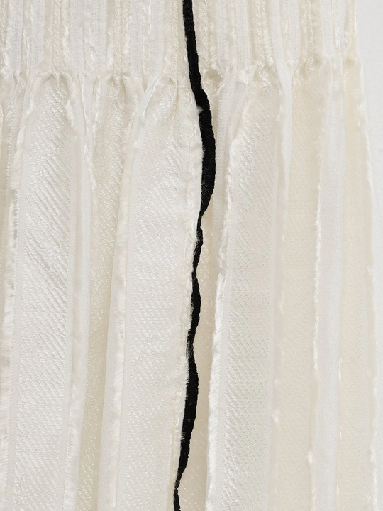 Close up of white skirt, showing texture of the viscose fabric