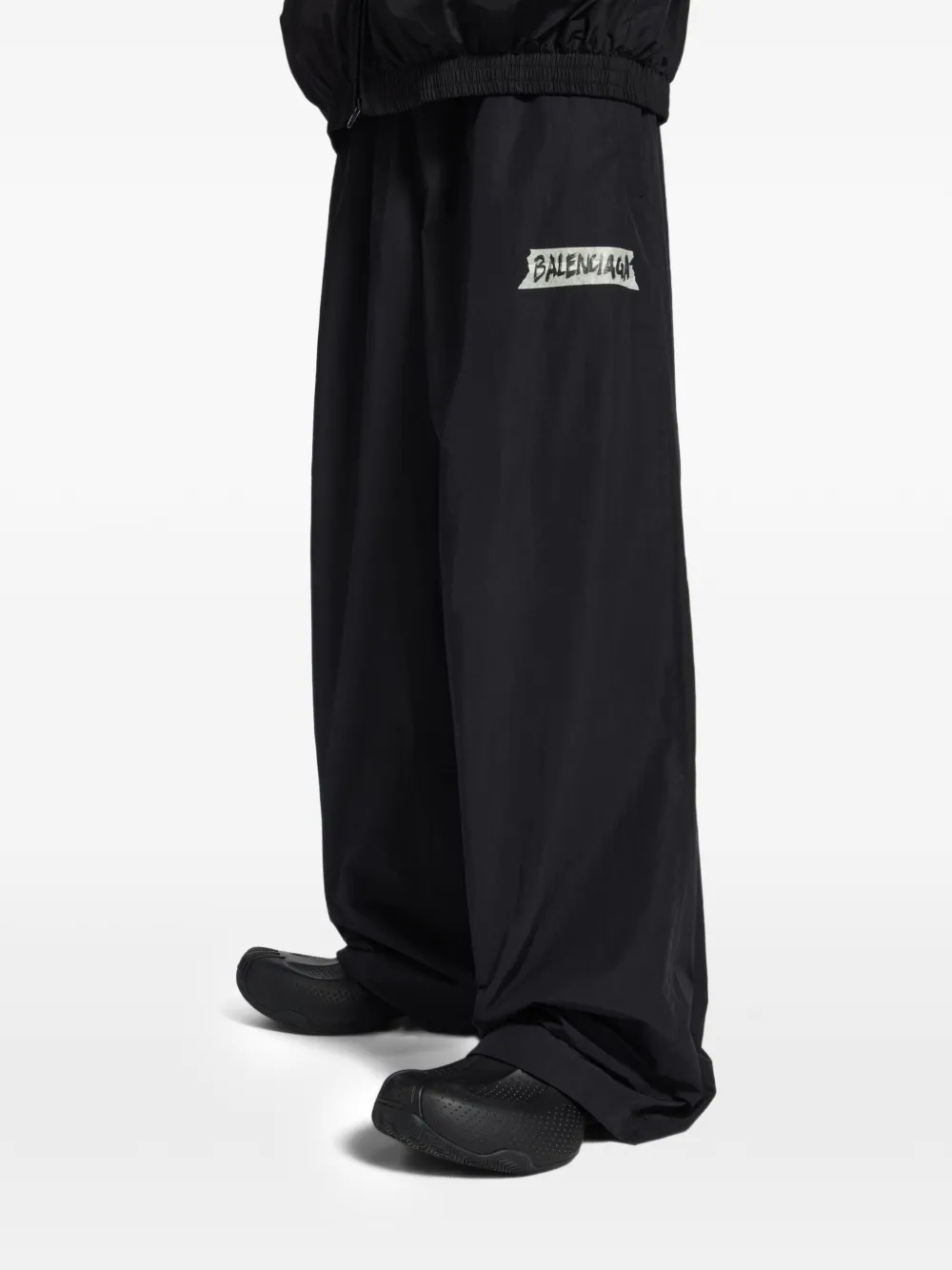 Black pants worn by a person, showing the pants fit