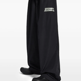 Black pants worn by a person, showing the pants fit