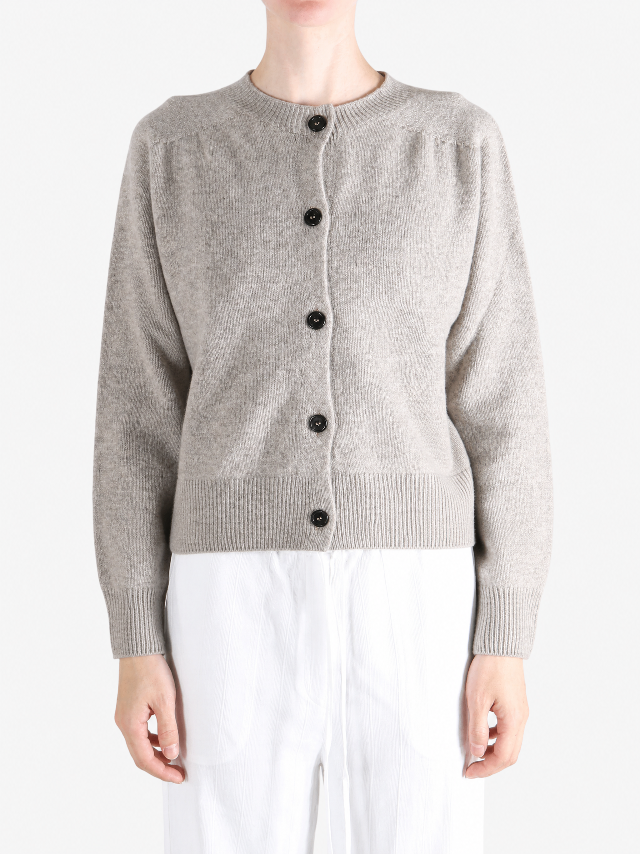 Grey knitwear worn by a person, showing the knitwear fit
