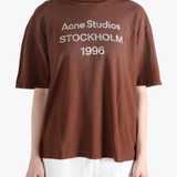 Brown t-shirt worn by a person, showing the t-shirt fit